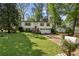 Traditional home featuring a well-maintained lawn, lush landscaping, and a two-car attached garage at 125 Roswell Farms Ln, Roswell, GA 30075