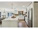 Bright kitchen featuring white cabinets, a center island, stainless steel appliances, and wood backsplash at 125 Roswell Farms Ln, Roswell, GA 30075