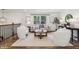 Cozy living area with plush chairs, hardwood floors, and staircase at 125 Roswell Farms Ln, Roswell, GA 30075