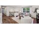 Open concept living area featuring cozy furniture, hardwood floors, and a staircase to the upper level at 125 Roswell Farms Ln, Roswell, GA 30075