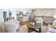 Bright living room and kitchen with hardwood floors, white cabinetry, and modern lighting fixtures at 125 Roswell Farms Ln, Roswell, GA 30075