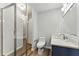 Modern bathroom with glass enclosed shower, wood look tile flooring, and updated vanity at 2804 Hall Se Dr, Smyrna, GA 30082