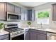 Close-up of a kitchen with stainless steel appliances and a double sink under a window at 2804 Hall Se Dr, Smyrna, GA 30082