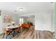 Cozy dining and living area featuring wood floors and an orange sofa at 2804 Hall Se Dr, Smyrna, GA 30082