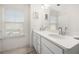 Bathroom with double sinks, quartz countertop, and large vanity mirror above at 813 Ambient Sw Way, Atlanta, GA 30331