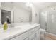 Bathroom with double sinks, quartz countertops, and glass-enclosed shower at 813 Ambient Sw Way, Atlanta, GA 30331