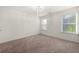 Light-filled bedroom with carpet, two windows with blinds, and crisp white walls at 813 Ambient Sw Way, Atlanta, GA 30331