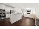 Open-concept kitchen and living area with hardwood floors and stainless steel appliances at 813 Ambient Sw Way, Atlanta, GA 30331
