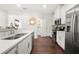 Bright kitchen boasts stainless appliances, white cabinets, and hardwood flooring at 813 Ambient Sw Way, Atlanta, GA 30331