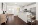 Modern kitchen with white cabinetry, stainless steel appliances, hardwood floors and bar top at 813 Ambient Sw Way, Atlanta, GA 30331