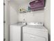 Neat laundry room with standard white washer and dryer, plus wire shelving at 813 Ambient Sw Way, Atlanta, GA 30331