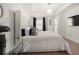 Main bedroom featuring a plush bed, stylish nightstand, and ample natural light at 813 Ambient Sw Way, Atlanta, GA 30331