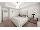 Main bedroom with tray ceiling, modern chandelier, plush bedding and ensuite access at 813 Ambient Sw Way, Atlanta, GA 30331