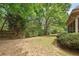 A view of the backyard with lush greenery and the side of a brick home at 891 Berryman Pl, Lawrenceville, GA 30045