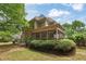 Spacious backyard with lush greenery and a screened-in porch on a brick home at 891 Berryman Pl, Lawrenceville, GA 30045