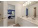 Bright bathroom featuring double sinks and a door open to the blue accent bedroom at 891 Berryman Pl, Lawrenceville, GA 30045