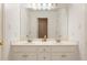 Clean bathroom featuring double sinks, ample counter space, and white cabinets at 891 Berryman Pl, Lawrenceville, GA 30045