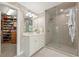 Bathroom with large glass shower and white vanity, next to a walk-in closet at 891 Berryman Pl, Lawrenceville, GA 30045