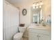 Bright bathroom with a vanity, toilet, and shower with white tile at 891 Berryman Pl, Lawrenceville, GA 30045