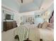 Spacious main bedroom featuring a tray ceiling, TV, and a sitting area by the windows at 891 Berryman Pl, Lawrenceville, GA 30045