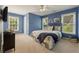 Bedroom with blue walls, a large window, and neutral carpet at 891 Berryman Pl, Lawrenceville, GA 30045