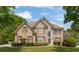 Charming brick two-story home featuring manicured landscaping, a gabled roof, and a grand entryway with large windows at 891 Berryman Pl, Lawrenceville, GA 30045