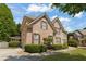 Lovely brick home showcasing a side-entry garage, lush greenery, and a well-paved driveway on a sunny day at 891 Berryman Pl, Lawrenceville, GA 30045
