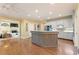 Open kitchen with stainless steel appliances, white cabinets, a center island, and view to the living room at 891 Berryman Pl, Lawrenceville, GA 30045