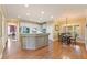 Open kitchen with stainless steel appliances, white cabinets, a center island, and a breakfast nook overlooking the yard at 891 Berryman Pl, Lawrenceville, GA 30045