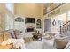 Bright living room with soaring ceilings, large windows, fireplace, built-ins, staircase and plush seating at 891 Berryman Pl, Lawrenceville, GA 30045