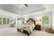 Spacious main bedroom featuring lots of windows, a king bed, and tray ceiling at 891 Berryman Pl, Lawrenceville, GA 30045
