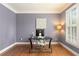 Calm, light-filled office with a sleek desk, neutral walls, a large window, and hardwood flooring at 891 Berryman Pl, Lawrenceville, GA 30045
