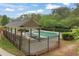 Community pool with covered seating area and secure fencing at 891 Berryman Pl, Lawrenceville, GA 30045