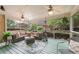 Relaxing screened-in porch with ceiling fans and comfortable seating for outdoor enjoyment at 891 Berryman Pl, Lawrenceville, GA 30045
