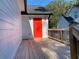 The bright red back door on the back porch is a striking focal point that enhances the exterior's appeal at 1384 Allegheny Sw St, Atlanta, GA 30310