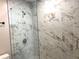 Sleek glass shower with marble tile, rainfall shower head, and modern fixtures at 1384 Allegheny Sw St, Atlanta, GA 30310
