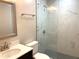Updated bathroom featuring a glass shower with marble tile and modern fixtures at 1384 Allegheny Sw St, Atlanta, GA 30310