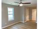 Bedroom with windows allowing natural light, hardwood floors and a ceiling fan at 1384 Allegheny Sw St, Atlanta, GA 30310