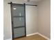 Modern bedroom with sliding barn door closet, new floors, and neutral paint at 1384 Allegheny Sw St, Atlanta, GA 30310