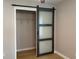 Bedroom closet featuring sliding barn door closure, new floors, and neutral paint at 1384 Allegheny Sw St, Atlanta, GA 30310
