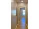 Inviting hallway with beautiful wood-look floors leading to a sunlit room with a large window at 1384 Allegheny Sw St, Atlanta, GA 30310
