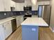 Modern kitchen with stainless appliances, white cabinets, quartz countertops, and a stylish island at 1384 Allegheny Sw St, Atlanta, GA 30310