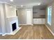 Bright living room features a fireplace, built-in cabinets and drawers, and hardwood flooring at 1384 Allegheny Sw St, Atlanta, GA 30310