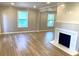 Bright living room featuring wood flooring, neutral walls, fireplace, and windows for lots of natural light at 1384 Allegheny Sw St, Atlanta, GA 30310