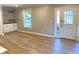Bright living room features a decorative front door with glass, built-in cabinets and drawers, and hardwood flooring at 1384 Allegheny Sw St, Atlanta, GA 30310