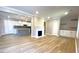 Open living area with fireplace, light wood floors, and seamless access to the modern kitchen at 1384 Allegheny Sw St, Atlanta, GA 30310