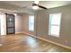 Main bedroom with wood floors and two ceiling fans, lots of natural light, and barn door closet at 1384 Allegheny Sw St, Atlanta, GA 30310