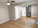 Main bedroom featuring wood floors, two ceiling fans, a barn door, and an ensuite bathroom at 1384 Allegheny Sw St, Atlanta, GA 30310