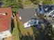 Aerial view of rear exterior showing manicured lawn, side driveway and mature trees at 1384 Allegheny Sw St, Atlanta, GA 30310