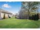 Expansive backyard with lush green grass, mature trees, and landscaping at 4410 Chaney Ct, Cumming, GA 30028